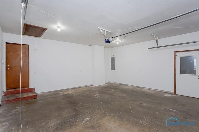 garage featuring electric panel and a garage door opener