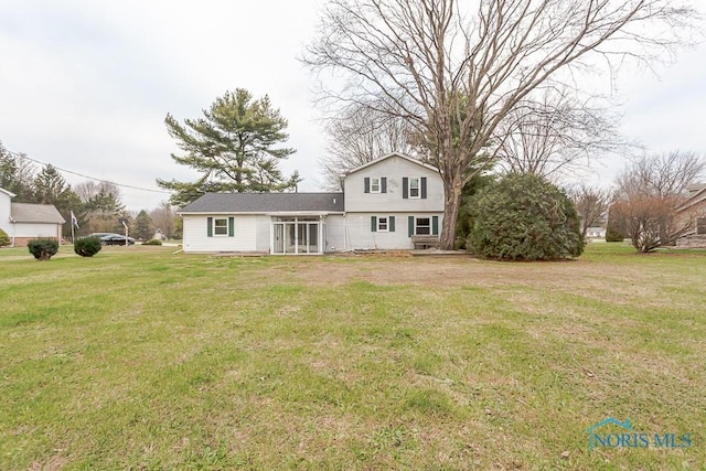 rear view of house with a yard