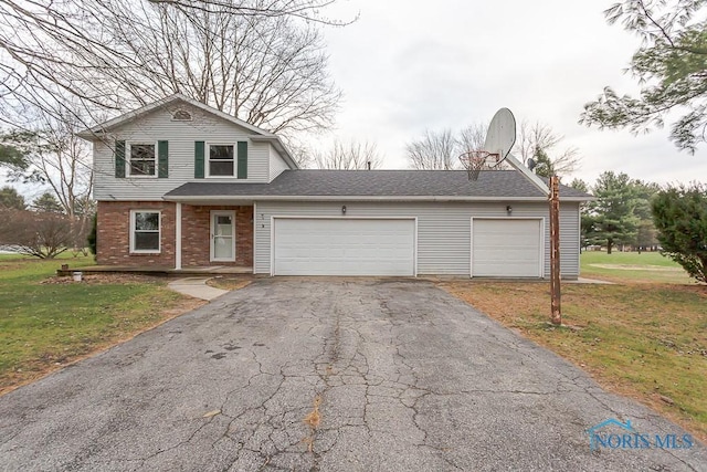 view of front property with a front yard and a garage