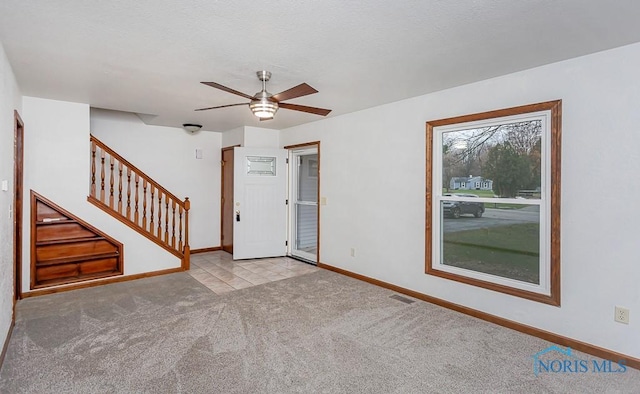 spare room with light carpet and ceiling fan