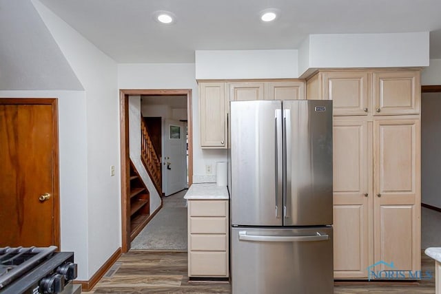 kitchen featuring stainless steel refrigerator, dark hardwood / wood-style flooring, and light brown cabinetry