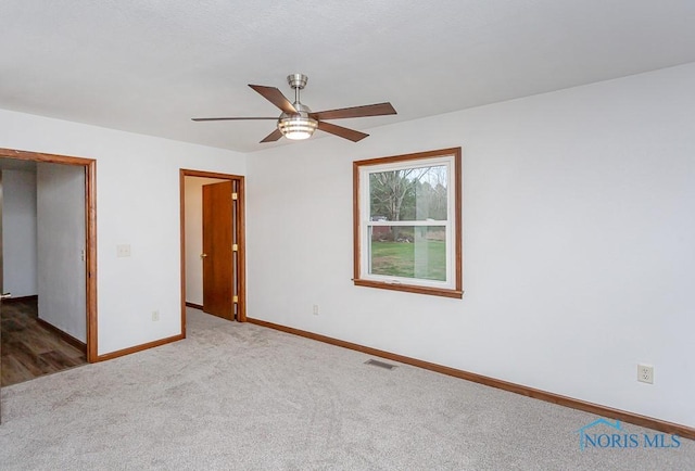 interior space with carpet flooring and ceiling fan