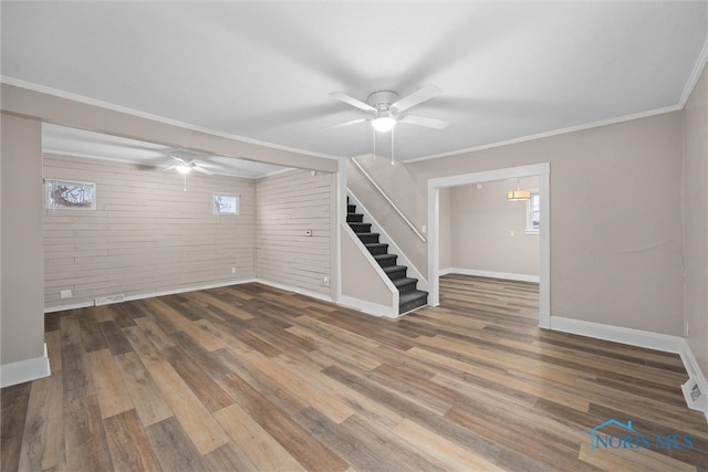 basement with hardwood / wood-style floors, ceiling fan, and crown molding