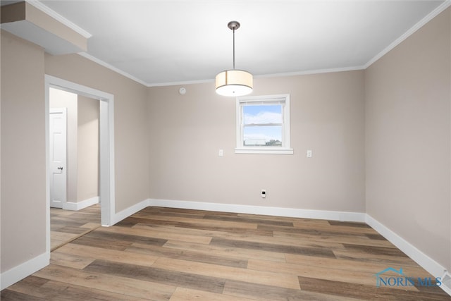 spare room with wood-type flooring and ornamental molding