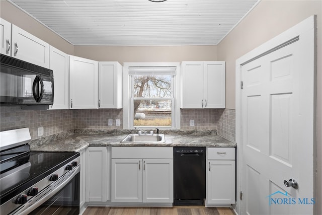 kitchen featuring black appliances, white cabinets, sink, light wood-type flooring, and tasteful backsplash