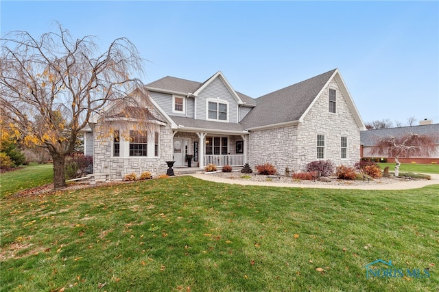 view of front facade with a front yard and covered porch