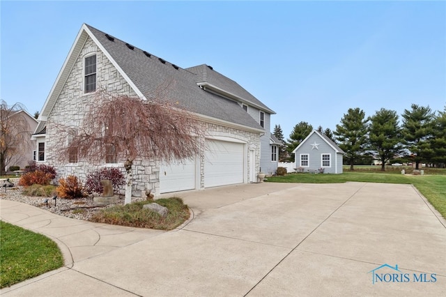 view of side of property featuring a lawn and a garage