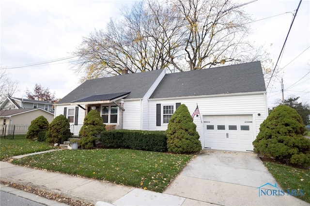 view of front of house featuring a garage and a front lawn