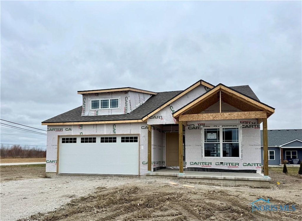 property in mid-construction with a garage and covered porch