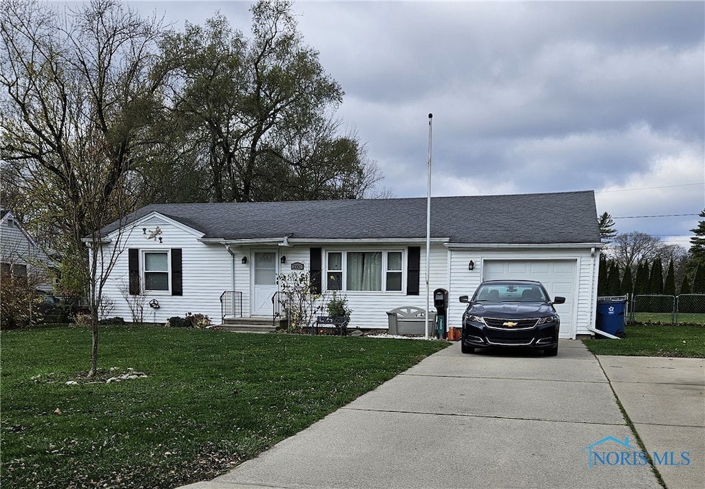 ranch-style home with a garage and a front lawn