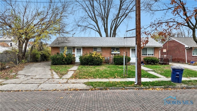 ranch-style home with a front yard