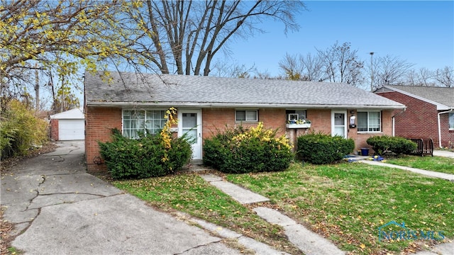 view of front of home with an outbuilding, a front lawn, and a garage