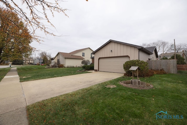 ranch-style house with a garage and a front lawn