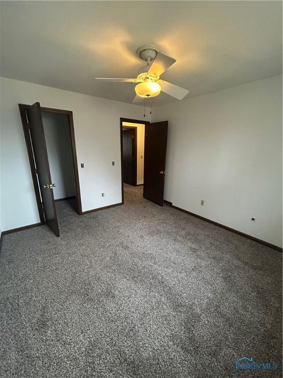 unfurnished bedroom featuring carpet flooring and ceiling fan