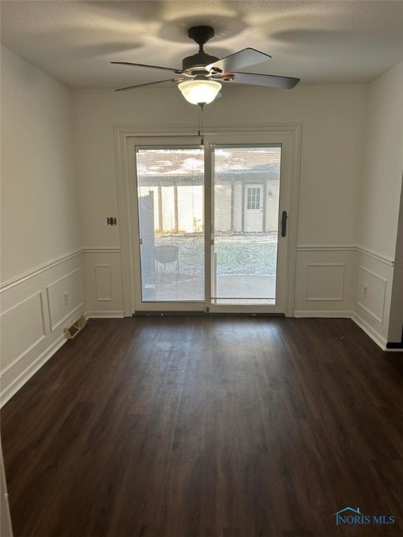 spare room with ceiling fan and dark hardwood / wood-style flooring