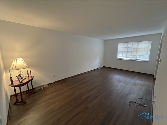 empty room featuring dark wood-type flooring