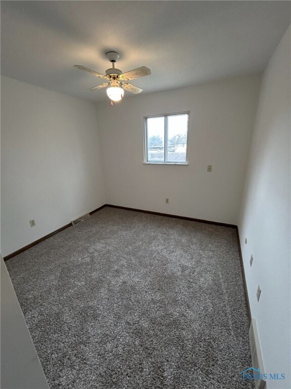 spare room with ceiling fan and carpet flooring