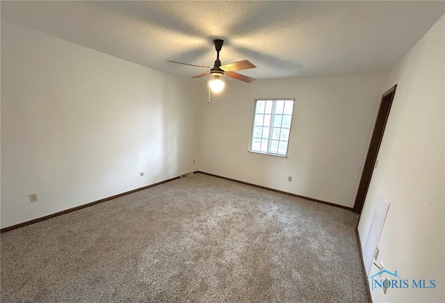 unfurnished room with ceiling fan and carpet flooring