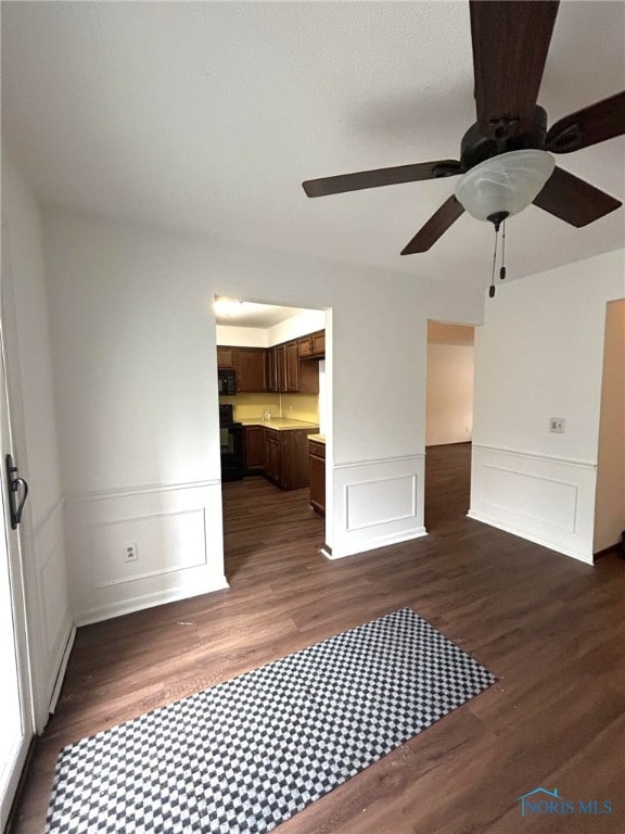 interior space featuring dark wood-type flooring and ceiling fan