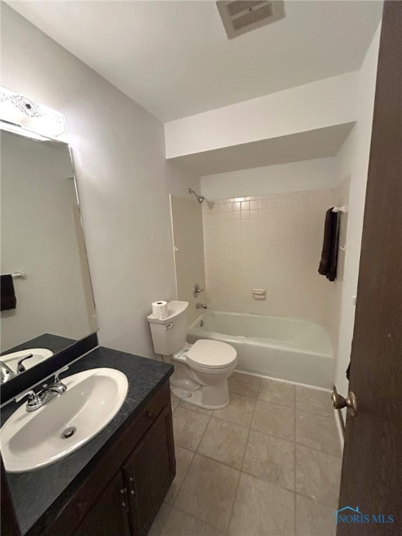 full bathroom with vanity, tiled shower / bath combo, and toilet