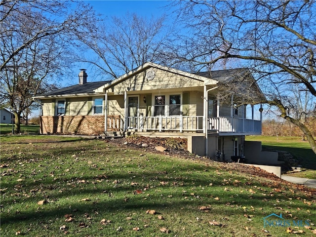 ranch-style home with covered porch and a front lawn