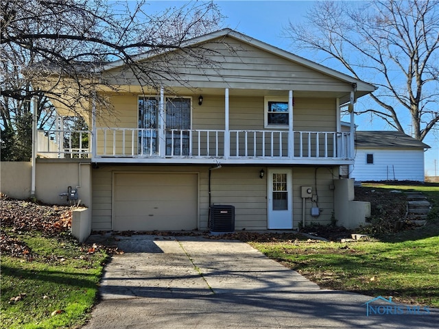 view of front of house featuring a garage and central AC unit