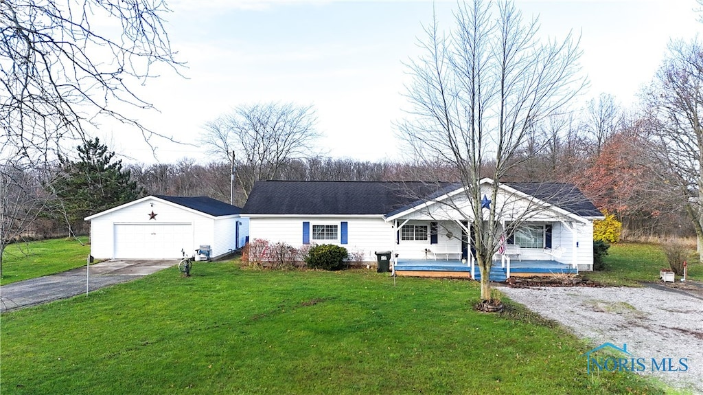 ranch-style house featuring covered porch and a front yard