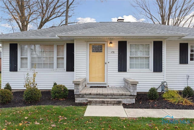 entrance to property with a yard