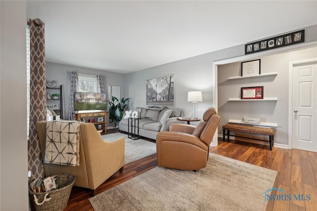 living room with dark hardwood / wood-style floors