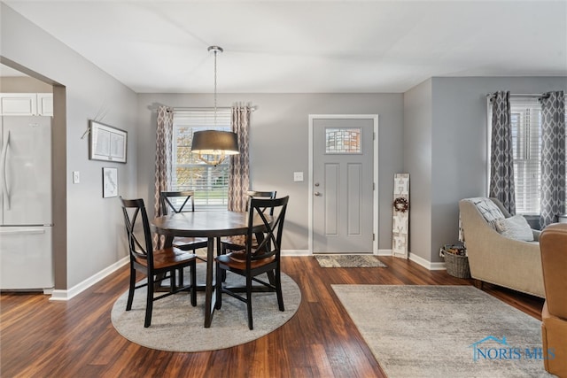 dining space featuring dark hardwood / wood-style floors