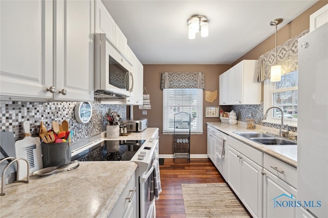 kitchen featuring a wealth of natural light, white cabinetry, sink, decorative light fixtures, and appliances with stainless steel finishes