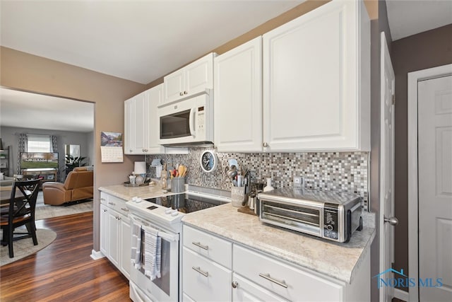 kitchen featuring dark hardwood / wood-style floors, white cabinetry, and white appliances