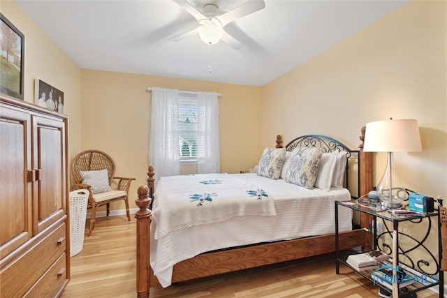 bedroom with light hardwood / wood-style flooring and ceiling fan