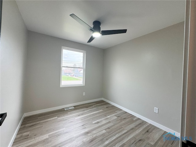 empty room with light hardwood / wood-style floors and ceiling fan