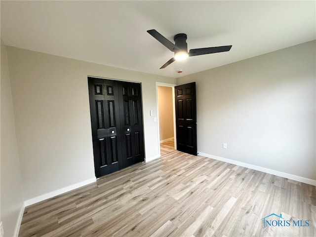 unfurnished bedroom with ceiling fan, a closet, and light hardwood / wood-style floors