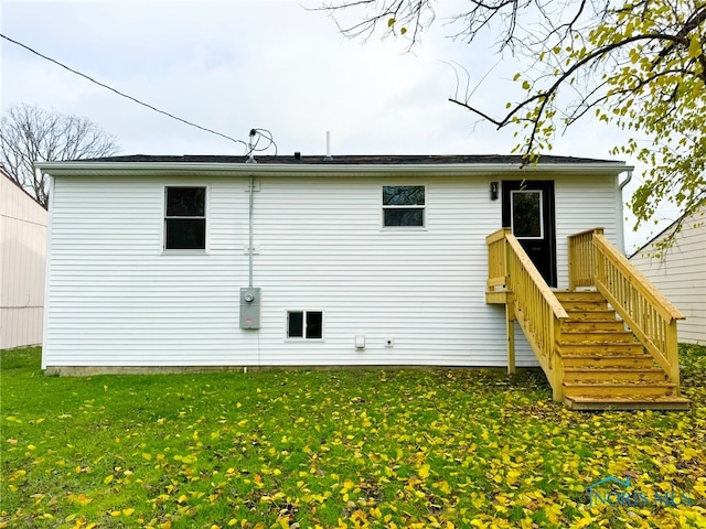 rear view of house featuring a lawn