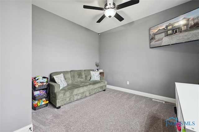 living area with ceiling fan and carpet flooring