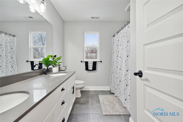 bathroom with toilet, vanity, a wealth of natural light, and a shower with curtain