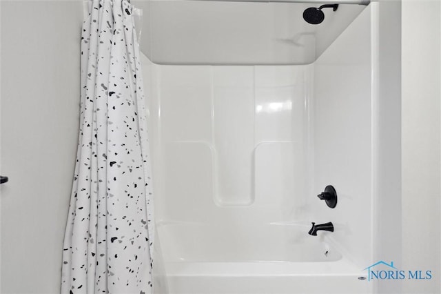 bathroom with shower / bath combo with shower curtain