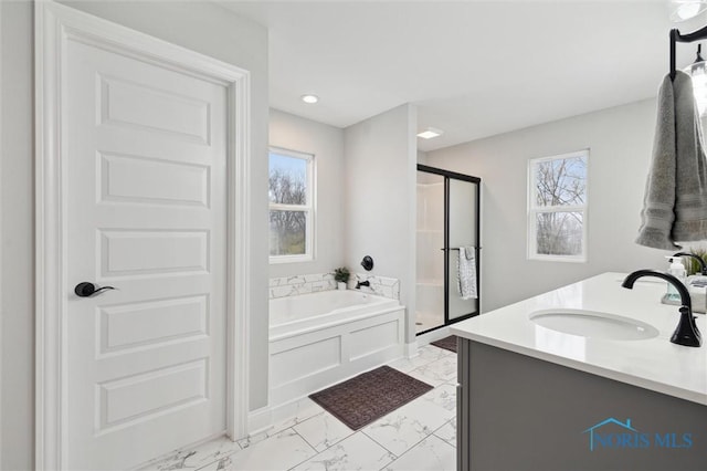 bathroom with separate shower and tub and vanity