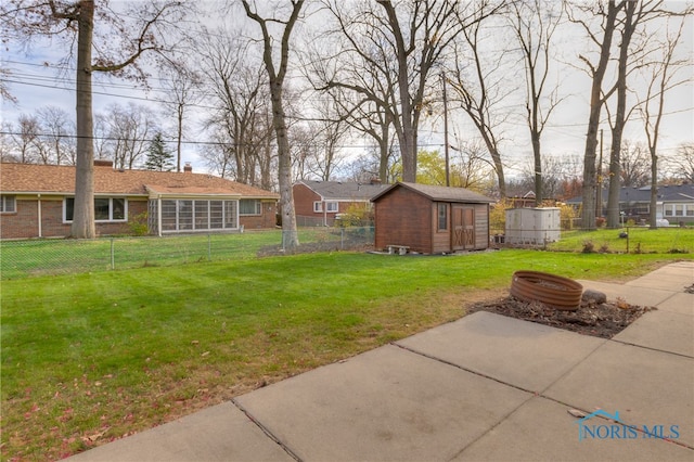 view of yard with a storage unit and a patio area