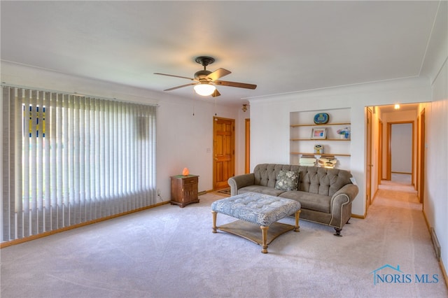 living room featuring light carpet, built in features, and ceiling fan