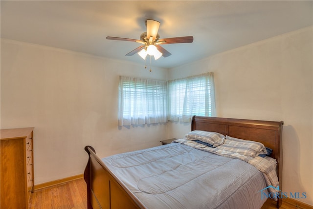 bedroom featuring light hardwood / wood-style floors and ceiling fan