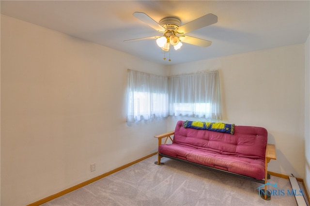 sitting room with carpet floors, baseboard heating, and ceiling fan