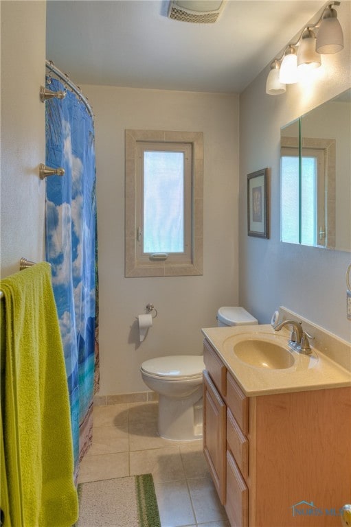 bathroom featuring walk in shower, tile patterned flooring, vanity, and toilet