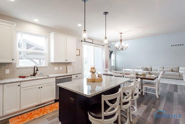 kitchen with white cabinets, dark wood-type flooring, and dishwasher