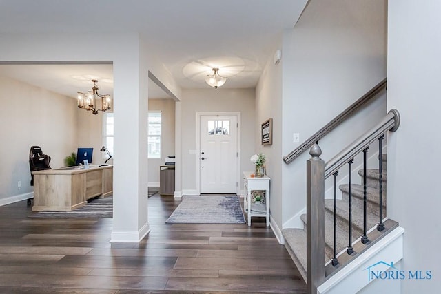 entryway featuring a notable chandelier and dark wood-type flooring