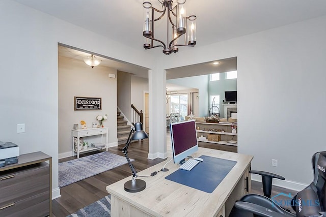 home office featuring a chandelier and dark wood-type flooring