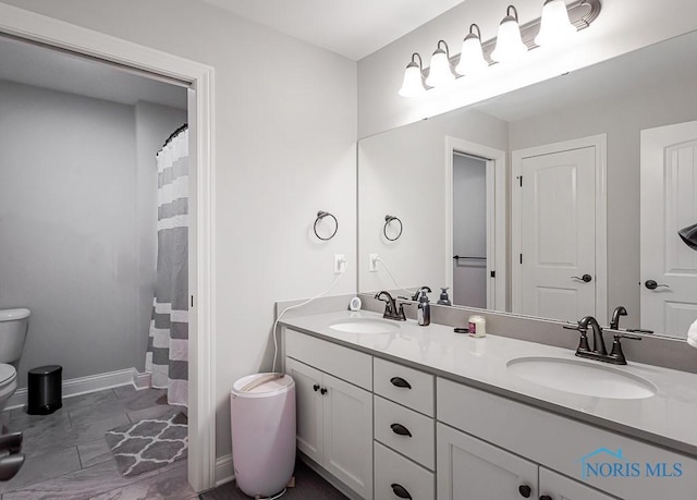 bathroom featuring vanity, a shower with shower curtain, and toilet