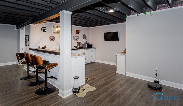 bar with white cabinetry and dark wood-type flooring